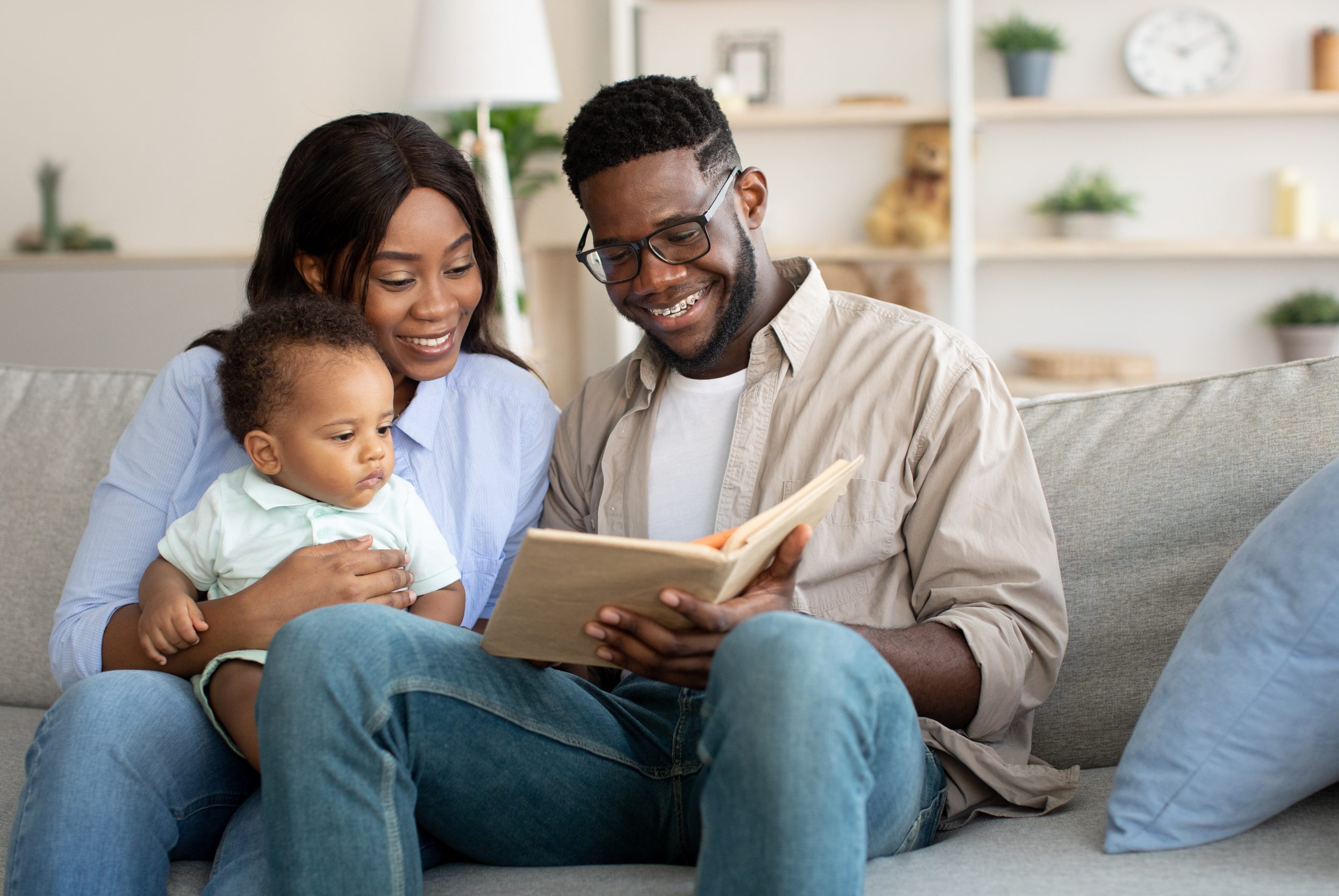 An image of parents reading to their young child