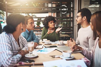 A group of people gathered around a table and talking