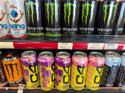 Monster and C4 energy drinks displayed on a store shelf