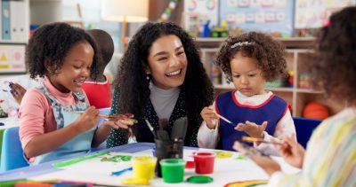 Preschoolers and teacher painting